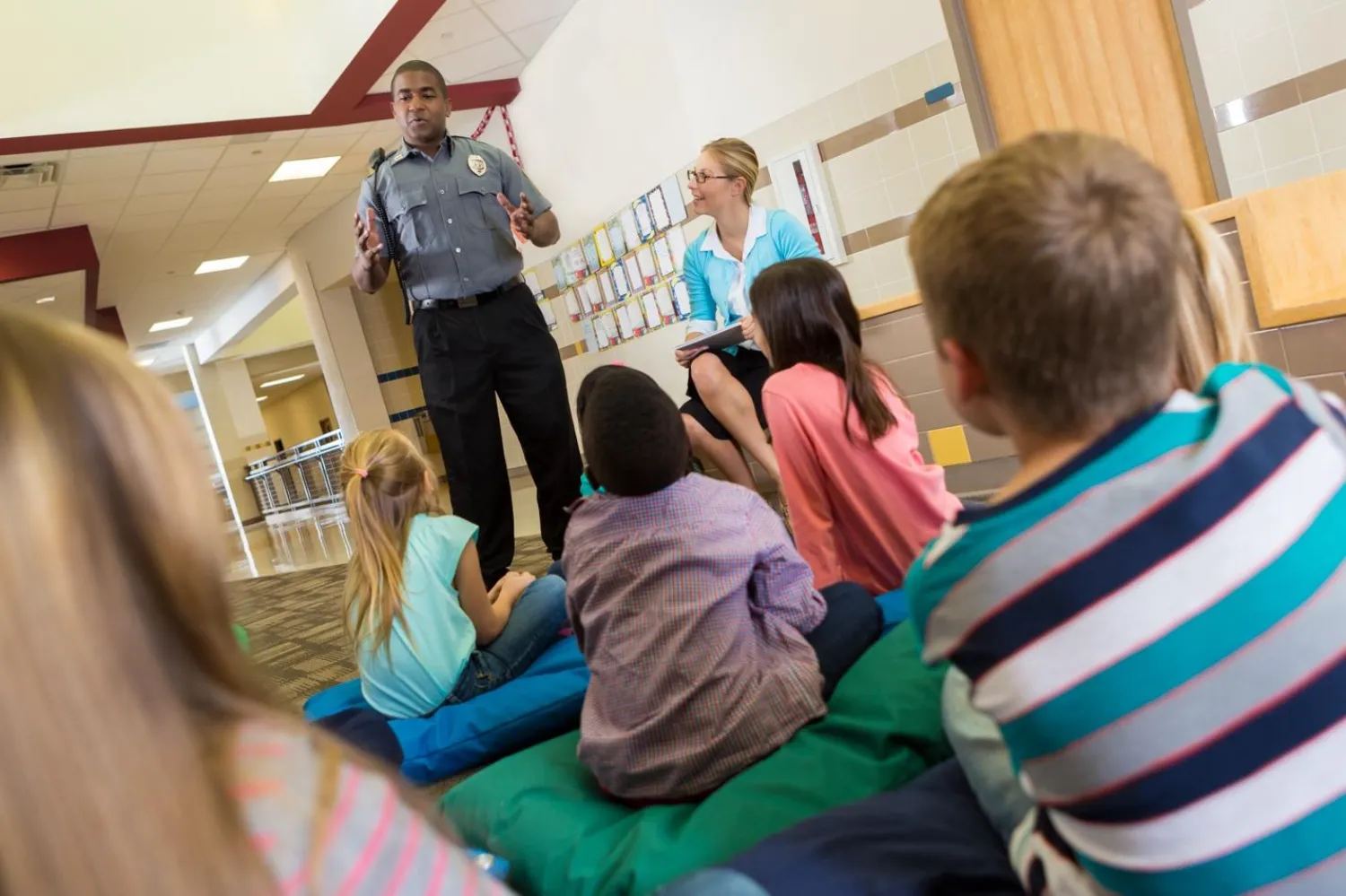 Police officer teaching children